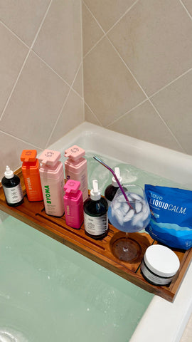 Bath set up with a glass of blue coconut Tavo LiquidCalm liquid calm drink as part of an evening wind-down ritual.