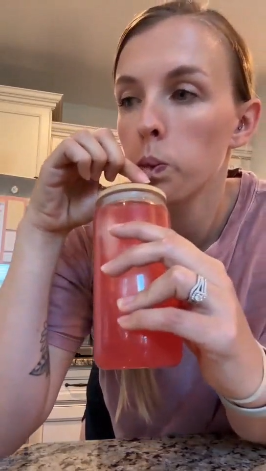 Video frame of a customer taking a sip of a pink Tavo LiquidCalm liquid calm drink 2.